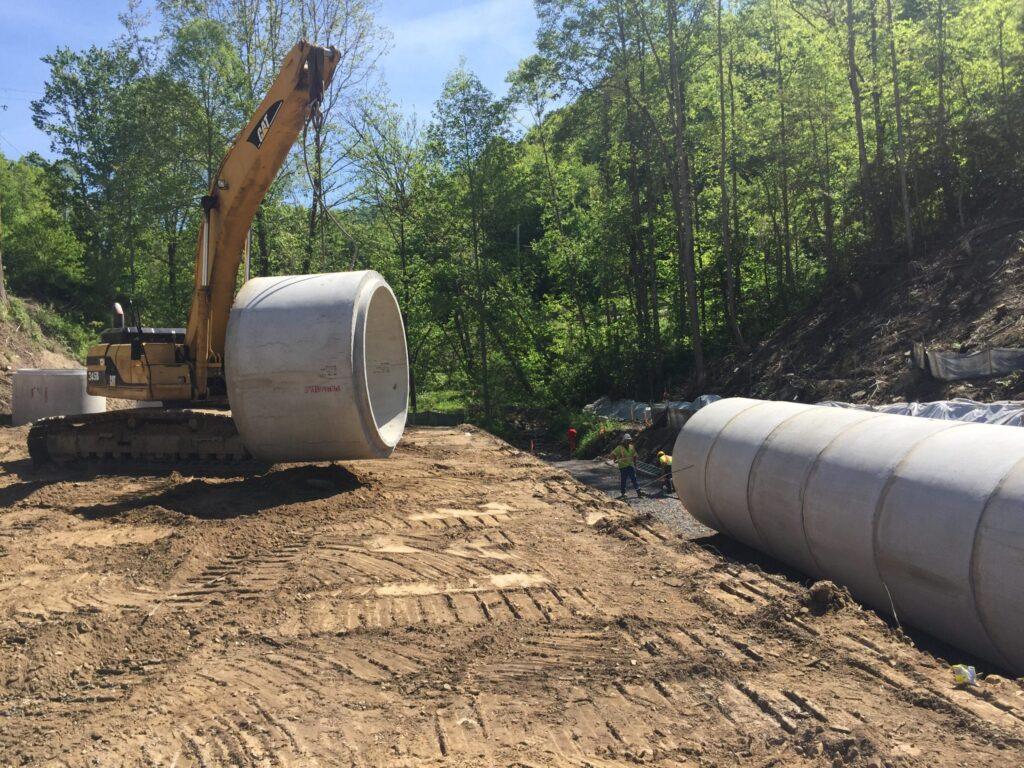 Large precast concrete pipe set in place by Permatile